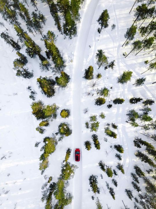 aerial-view-of-red-car-driving-through-the-white-s-NBZCPLJ-scaled-1.jpg
